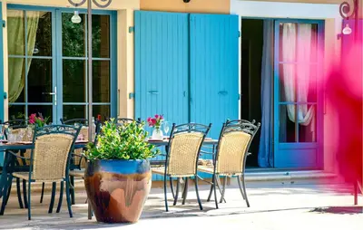 a table and chairs in front of a building at Maison Avec Piscine Privée in Villars