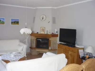 a living room with a white couch and a television at Holiday Home by Interhome in Pierrevert