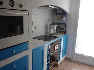 a kitchen with blue cabinets and a sink at Holiday Home by Interhome in Pierrevert