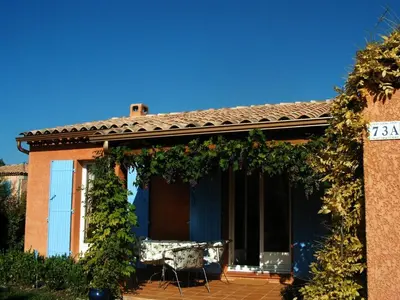 a house with a porch with a bench on it at Holiday Home by Interhome in Pierrevert