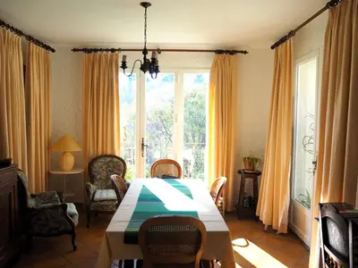 a dining room with a table and chairs and a window at Holiday Home Charmantes Landhaus mit Garten by Interhome in Pierrevert
