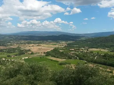 an aerial view of a green field and mountains at Apartment Morard - Bonnieux Appt Les Ocres by Interhome in Bonnieux