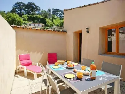 a table and chairs sitting on a patio at Apartment Morard - Bonnieux Appt 2- Etage by Interhome in Bonnieux