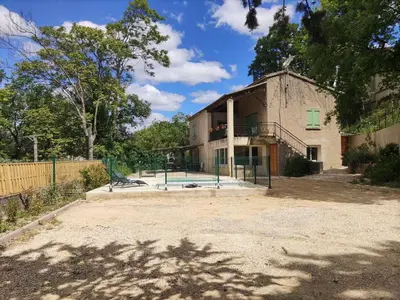an old building with a playground in front of it at Holiday Home Villa Roche en Provence Süd Luberon by Interhome in Ansouis