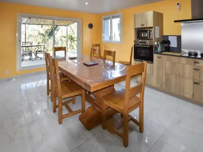a kitchen with a large wooden table and chairs at Holiday Home Villa Roche en Provence Süd Luberon by Interhome in Ansouis