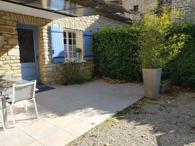 a patio with a table and a chair in front of a house at Holiday Home Schöne provenzalische Villa Les Carlets mit Pool by Interhome in Saignon