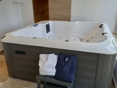 a bathroom with a bath tub with a sink at Apartment Valentins Gîte Moulin de Tartay in Avignon by Interhome in Avignon