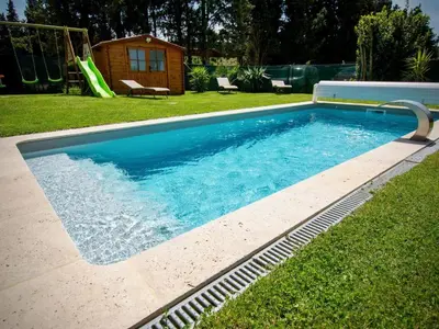 a swimming pool in a yard with a slide at Apartment Valentins Gîte Moulin de Tartay in Avignon by Interhome in Avignon