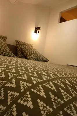 a bedroom with a bed with a brown and white comforter at Apartment Valentins Gîte Moulin de Tartay in Avignon by Interhome in Avignon