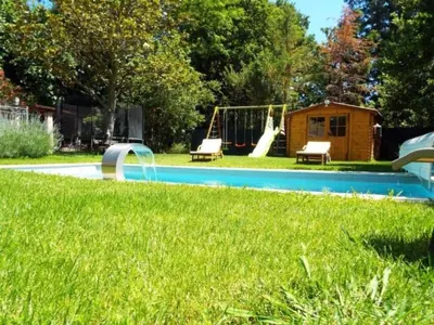 a backyard with a playground with a swing at Apartment Leonie's Gîte Moulin de Tartay in Avignon by Interhome in Avignon