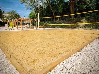 a volleyball court with a net and a playground at Holiday Home Moulin de Tartay in Avignon by Interhome in Avignon