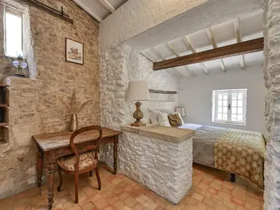 a bedroom with a bed and a desk and a table at Holiday Home Domaine Santonne by Interhome in Apt