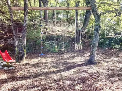 a swing set in a yard with trees at Holiday Home Domaine Santonne by Interhome in Apt