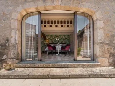 an archway leading to a patio with a table and chairs at Holiday Home Das Atelier im Mas Naste by Interhome in Eygalières
