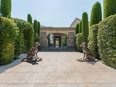 two statues of two dogs in a courtyard at Holiday Home Das Atelier im Mas Naste by Interhome in Eygalières