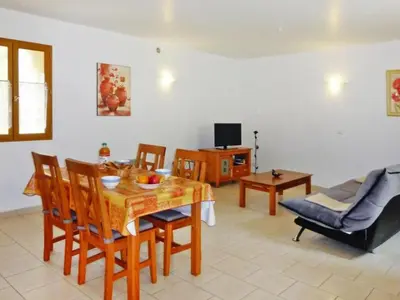 a living room with a table and chairs and a couch at Apartment Morard - Bonnieux Appt Bleu Provence by Interhome in Bonnieux