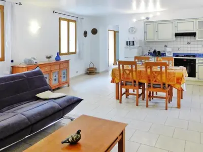 a living room and kitchen with a table and a couch at Apartment Morard - Bonnieux Appt Bleu Provence by Interhome in Bonnieux