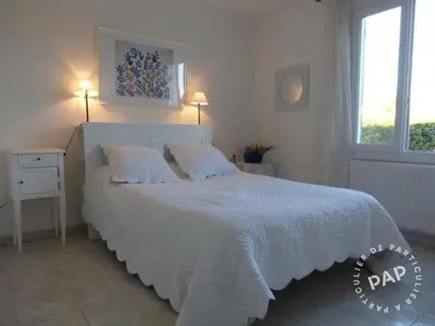 a bedroom with a large white bed with two pillows at Villa en Provence in Le Thor