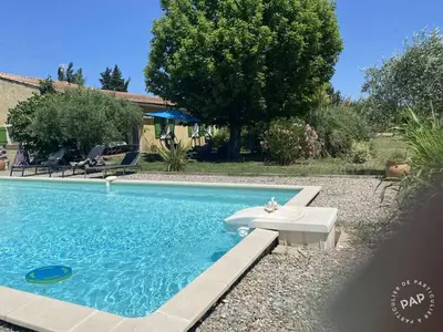 a swimming pool with a white bench next to a house at Villa en Provence in Le Thor