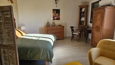 a living room with two chairs and a table at Maison de charme vue sublime et rooftop in Lioux