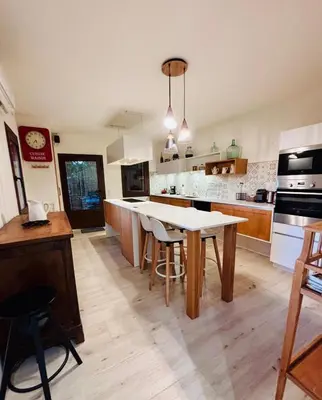 a kitchen with a table and chairs in it at Maison de charme vue sublime et rooftop in Lioux