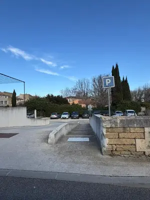 a parking lot with cars parked on a street at La Casa Grans - Charme et calme en Provence in Grans