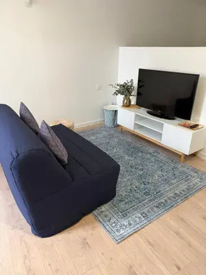 a living room with a couch and a flat screen tv at La Casa Grans - Charme et calme en Provence in Grans