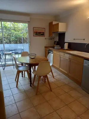 a kitchen with a table and chairs and a dining room at Hébergement tout confort au pied du Luberon in Cabrières-dʼAigues