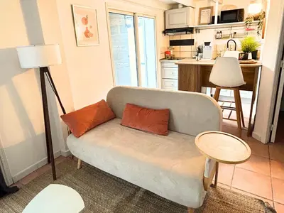 a living room with a couch and a table at Maison cosy avec parking privé proche centre Aix en Provence in Aix-en-Provence