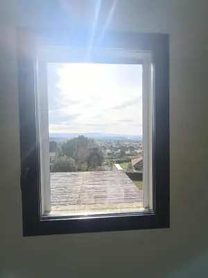 a window with a view of a roof at ChloLéa in Caromb