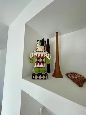 a shelf with a figurine of a cat on it at Lourmarin, Maison De Charme Au Coeur Du Luberon in Cadenet