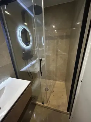 a glass shower in a bathroom with a sink at Studio 2 personnes maximum in Saint-Andiol