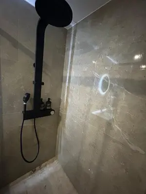 a shower in a bathroom with a phone on the wall at Studio 2 personnes maximum in Saint-Andiol