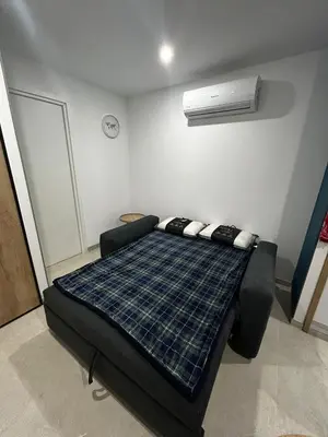 a room with a bed in a room with a fan at Studio 2 personnes maximum in Saint-Andiol