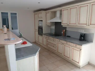 a kitchen with wooden cabinets and a counter top at Luberon Sud in La Tour-dʼAigues