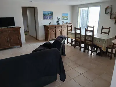 a living room with a couch and a table and chairs at Luberon Sud in La Tour-dʼAigues