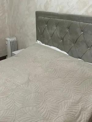 a bed with a metal headboard and a white bedspread at Le Pavillon Etoile in Venelles