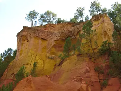 a painting of a cliff with trees on it at LAVANDE in Apt