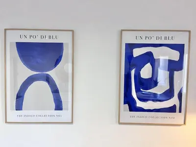 two framed pictures of a blue chair on a wall at Aix-en-Provence, Studio rénové au coeur de ville Calme absolu in Aix-en-Provence
