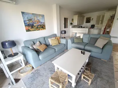 a living room with two blue couches and a table at Maison climatisée 6 pers. avec piscines au Domaine Pont Royal - FR-1-658-38 in Mallemort