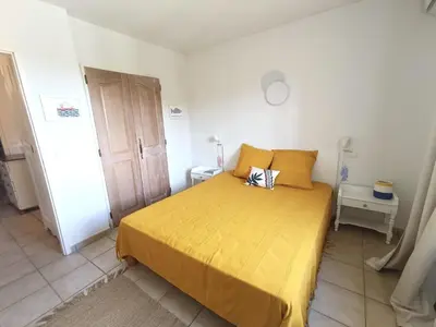 a bedroom with a bed with a yellow bedspread at Maison climatisée 6 pers. avec piscines au Domaine Pont Royal - FR-1-658-38 in Mallemort