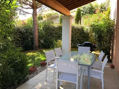 a table and white chairs on a patio at Maison climatisée 6 pers. avec piscines au Domaine Pont Royal - FR-1-658-38 in Mallemort