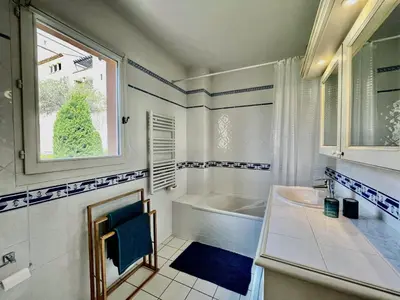 a bathroom with a tub and a sink and a window at Maison climatisée 6 pers. avec piscines au Domaine Pont Royal - FR-1-658-38 in Mallemort