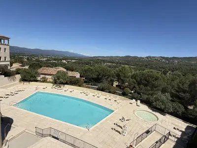 an overhead view of a swimming pool with chairs at Maison climatisée 6 pers. avec piscines au Domaine Pont Royal - FR-1-658-38 in Mallemort