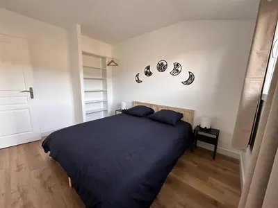 a bedroom with a bed with two pillows on it at L'abeille sous les étoiles in Saint-Michel-lʼObservatoire