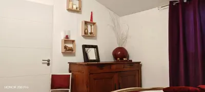 a room with a wooden dresser with a vase on it at Charmant studio aux portes des Alpilles in Eyguières