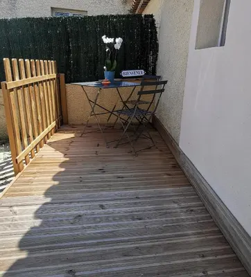 a table on a porch with a plant on it at Charmant studio aux portes des Alpilles in Eyguières