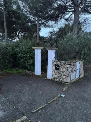 a stone wall with a gate and a fence at T2 avec Terrasse à Ventabren proche Aix in Ventabren