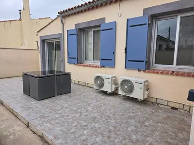 a house with two air conditioners on the side of it at Le cocon de mag in Miramas