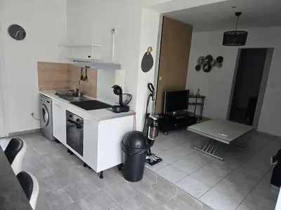 a kitchen with a sink and a stove top oven at Le cocon de mag in Miramas